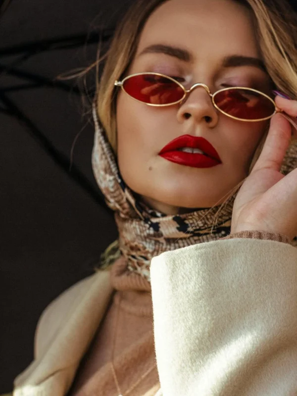 blonde woman with red glasses